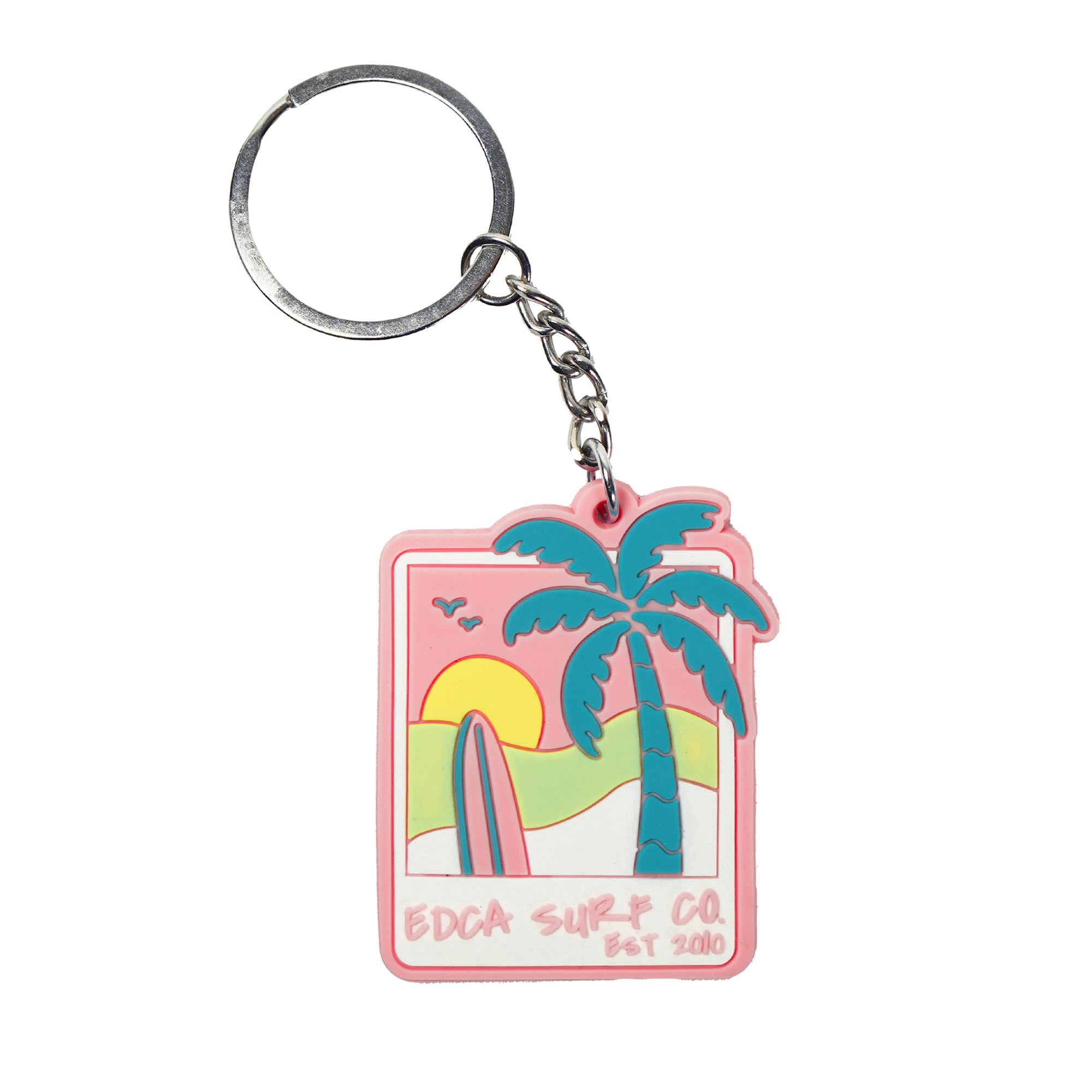 pink keychain showing an image of a sunset displaying the words "EDCA Surf Co"